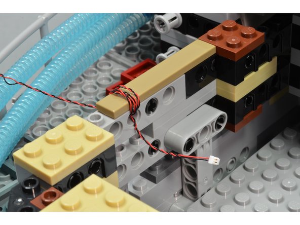 The third photo shows how excess cable can be wrapped around plates or bricks.