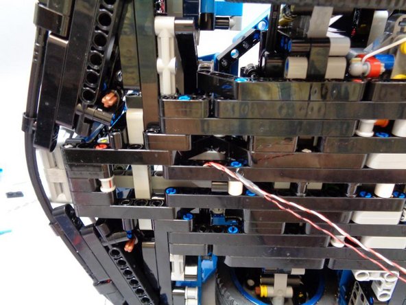 As shown in the second photo, remove the rear-view mirror on the RIGHT side of the vehicle.  This will make it easier to turn the car on its side to route the wires.