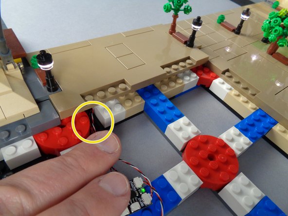 As shown in the photos for this step, re-attach Panel 3R to the Eiffel Tower base.