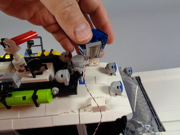 As shown in the first photo for this step, carefully attach the front lightbar.