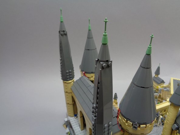 As shown in the photos for this step, replace the two rear towers you removed when you began working on the second half of the castle.