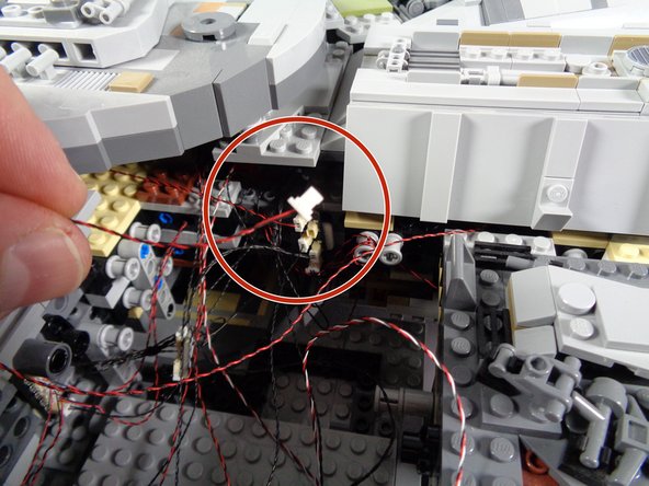 The first photo in this step shows the docking bay light assembly from when you first installed your Falcon lighting kit.  That was probably a long time ago, so we wanted to show the photo of what the assembly looked like.  You do not need to remove the assembly now-- this photo is just to remind you.