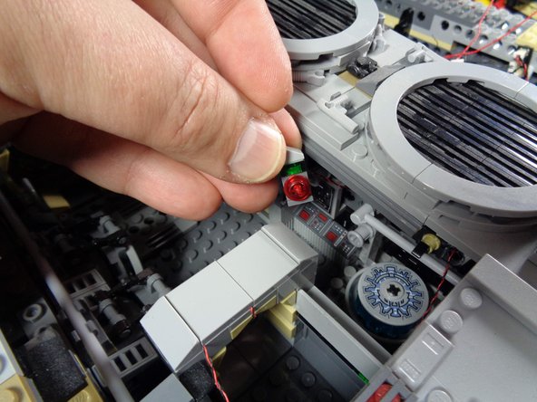 Next, you will remove the control panel brick from the area next to the hyperdrive, as shown in the first photo.