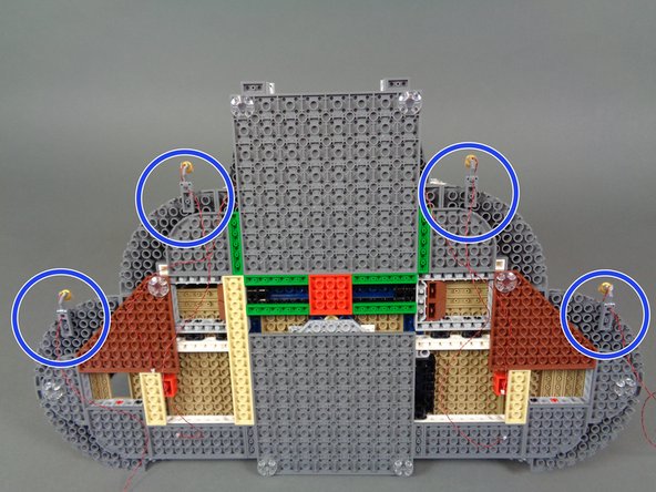 The warm white spotlights bag contains eight spotlights.  You will mount four of them on the lower castle level.