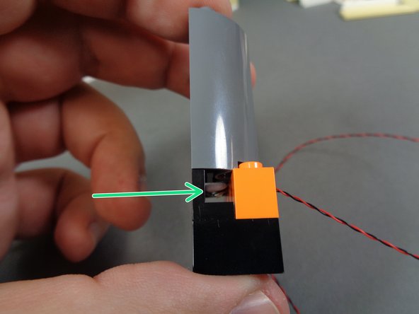 You should now have the re-assembled stove with the orange Pico LED light mounted in the open space under the half-cylinder as shown by the green arrow in the third photo.