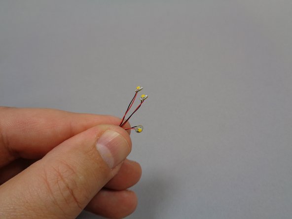 Open Bag 8, and remove three of the lights with 12&quot; cables (see the first photo).