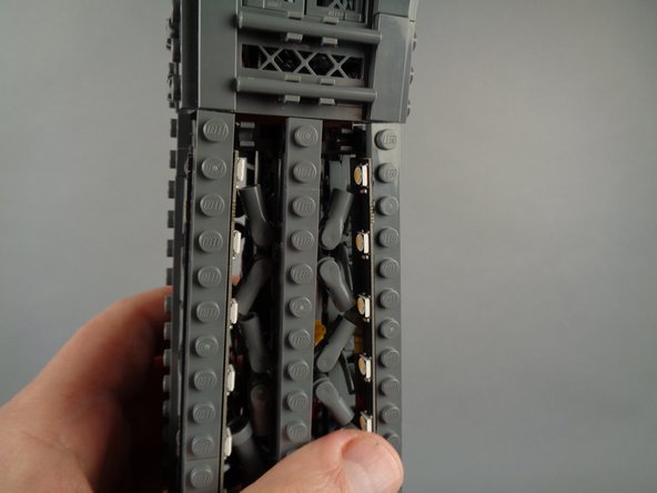 As shown in the photos for this step, attach the top of strip #1 to the tower frame, and re-position brace elements as needed to make room for the LED lights and strip.