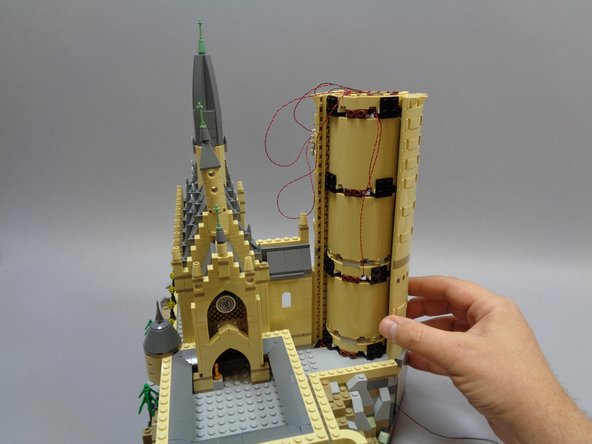 As shown in the first photo carefully re-attach the long tower panel.