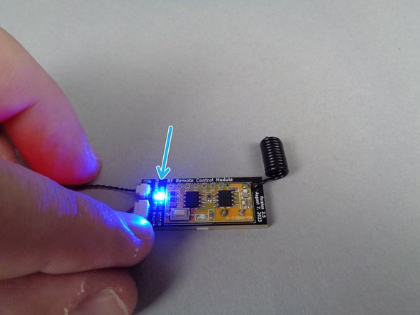 The red arrow in the first photo in this step shows the red power LED light on the remote receiver board.  Make sure this light is on before proceeding.