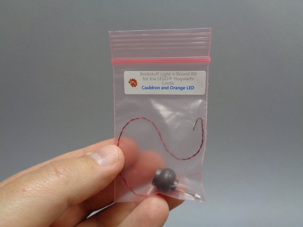 Inside Bag 10 should be a smaller bag labeled &quot;Cauldron and Orange LED&quot;.  Inside that bag will be a replacement LEGO® cauldron with a hole drilled in the bottom.