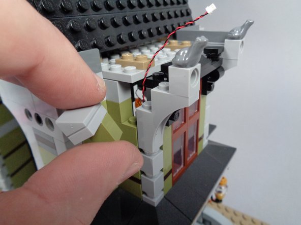 You should be able to pull the wire through the hole without too much force.  Be careful not to pinch too tightly or pull to hard on the plug itself, or it can become damaged.