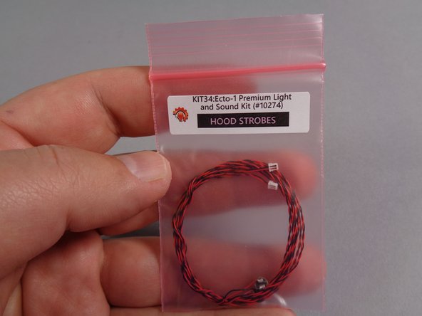 Inside your &quot;MAIN CHASSIS PARTS&quot; bag, there will be a smaller pink bag labeled &quot;HOOD STROBES.&quot;  Open this bag and carefully remove the two lights inside.