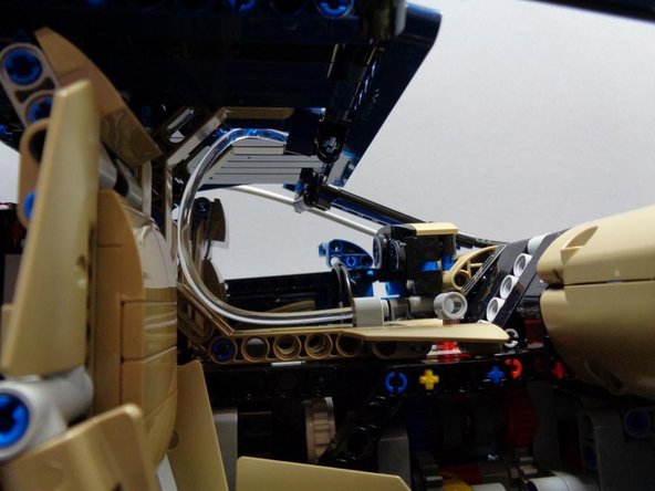 Carefully bend the short clear fiber optic pipe included in Bag 4 and insert it the same way as the original LEGO® tube that came with your Bugatti. (see the third photo)