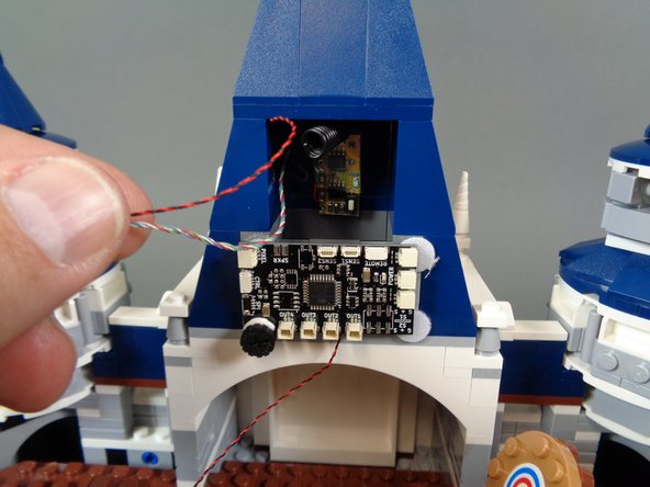 Make sure the two remote control receiver wires pass above, not under, the master controller board as shown in the third photo.