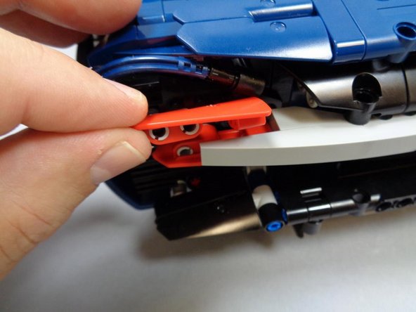 As shown in the second photo, remove the top left red tail light cover.