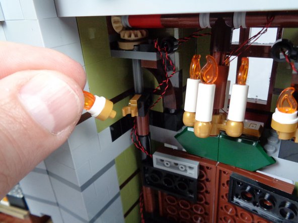 As shown in the second and third photos for this step, remove the left and right un-lit sconces from your mansion entryway.