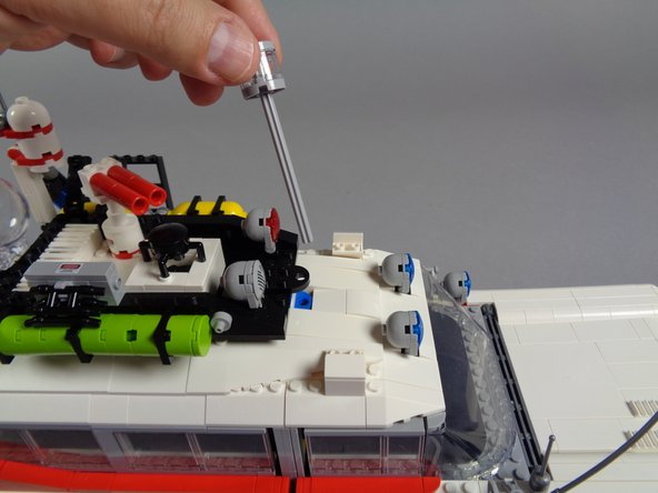 As shown in the third photo, remove the large strobe/steering brick along with its axle.