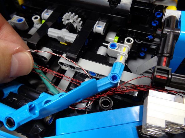 As shown in the third photo, replace the bracket you removed in the beginning of this step.