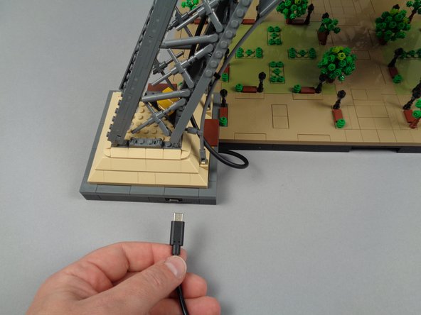 Connect your USB-C power supply to mains power.  As shown in the first two photos for this step, connect the USB-C power plug to the connector in the base of your Eiffel Tower.