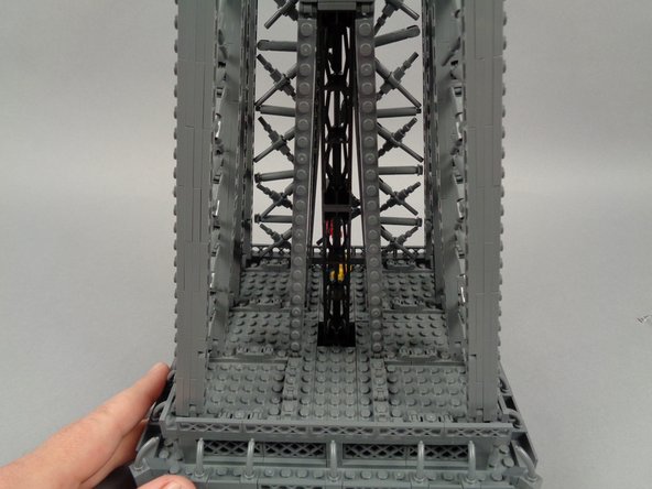 As shown in the photo for this step, you should now have clear access to the lower rear of the top tower section.