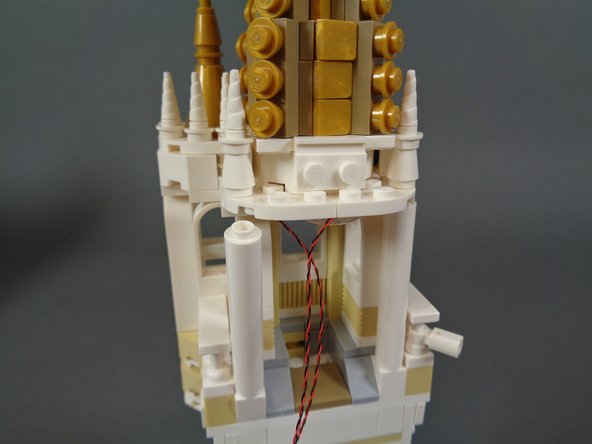 As shown in the first photo for this step, carefully loosen the left pillar.