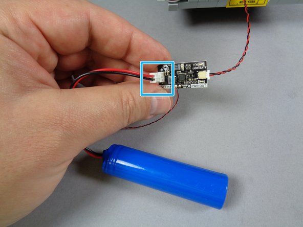As shown by the blue square in the second photo, connect your LiPo battery of choice to the large plug on the LiPo power supply.