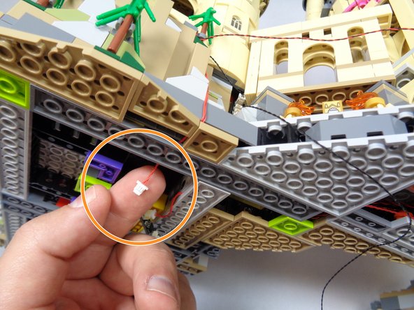 As shown in the first two photos, remove two plates from under the castle base.