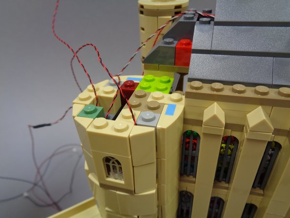 When you have re-attached all tan parts, you should have three light wires extending out the top of the tower as shown in the third photo.