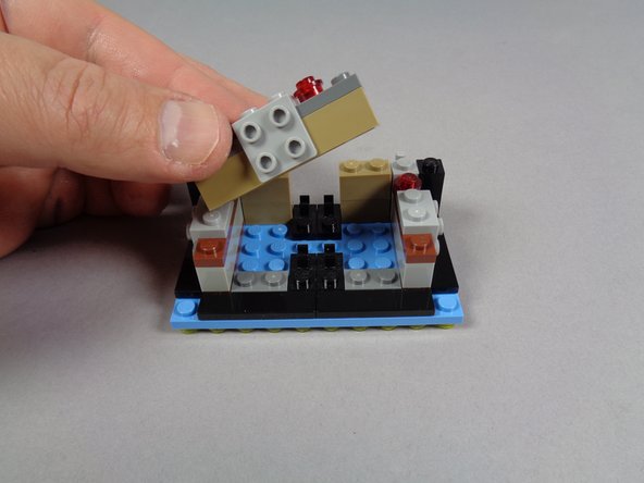 As shown in the photos for this step, continue disassembling the marquee bottom by removing the front and side inner sections.