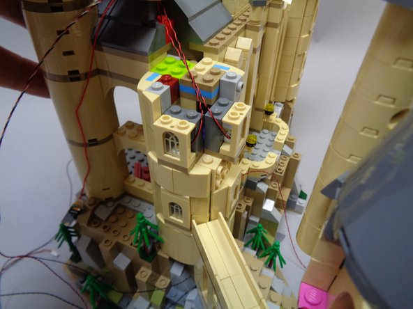 As shown in the third photo, once all lights are mounted, you should have three light wires extending upward toward the top of the tower.