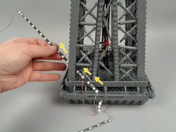 To prepare, feed the strips connected to plug #1 on the adapter board through the center of the pillar as shown by the yellow arrows in the second photo.