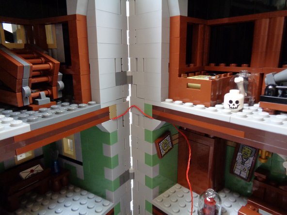 As shown in the third photo, the red wire should bend up or down when you close the house.