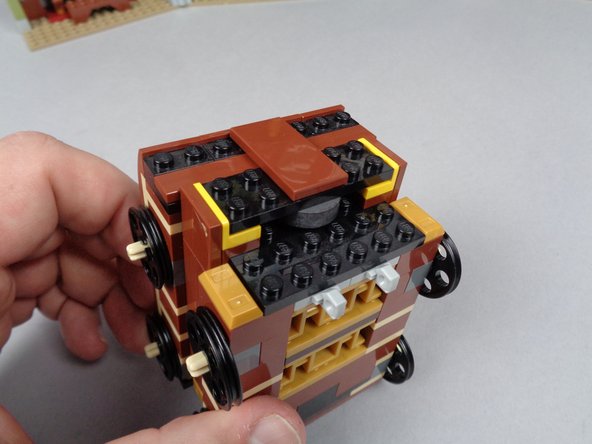 As shown by the green arrows in the second photo for this step, the black plate might bend slightly sitting on top of the magnet (the magnet may be slightly taller than the distance below the black plate).  This is ok, and you should be able to re-attach all LEGO pieces so they hold in place even if the black plate bends slightly.