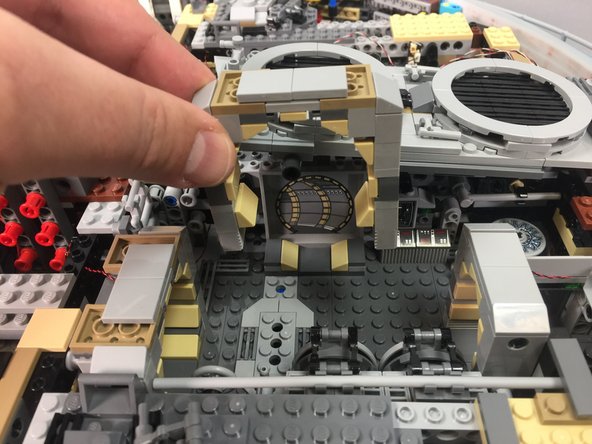 As shown in the photos for this step, remove the top of the third door frame in the rear interior space.