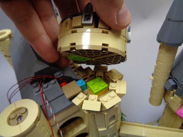 Re-attach the larger top tower piece as shown in the first photo.