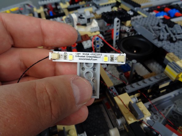 Remove the cool white light strip and 2x4 LEGO plate from inside the Landing Lights Parts Bag.