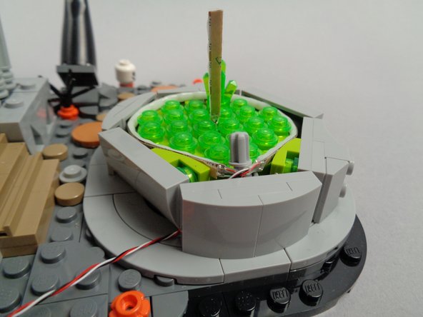 The third photo for this step shows how the light strip wire should exit from the back of the fountain.