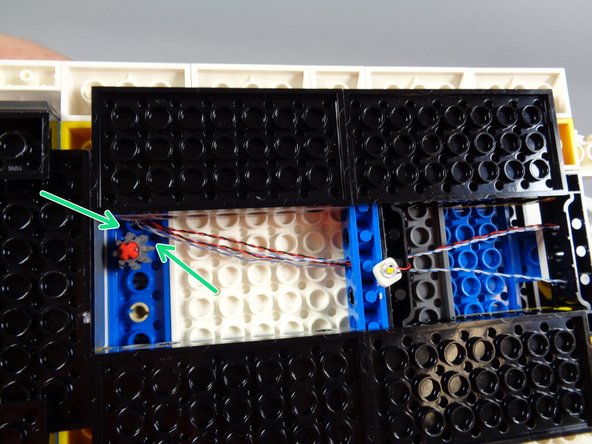 As shown by the green arrows in the photo for this step, make sure the wires are not stuck in the gear.  It is critical that the roof radar be able to rotate freely without catching any of the wires.