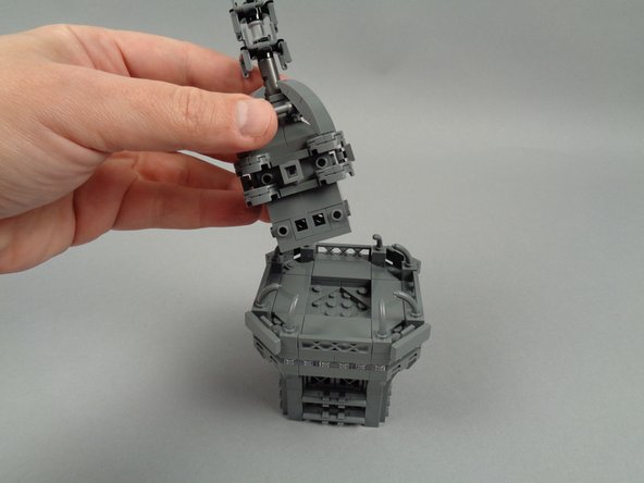 As shown in the photos for this step, remove the broadcast tower section from the top of your Eiffel Tower, and also remove the antenna assembly from the center of the tower top.