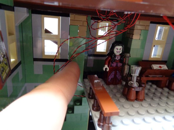 As shown in the second photo, use your finger to move all light wires to the left side of the floor section.