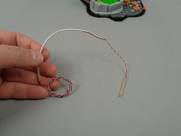 The photo for this step shows the LED strip for the fountain.  This strip is divided into two segments: one longer segment (for the fountain base) and one short segment (for the flow coming out of the monster's mouth into the fountain).