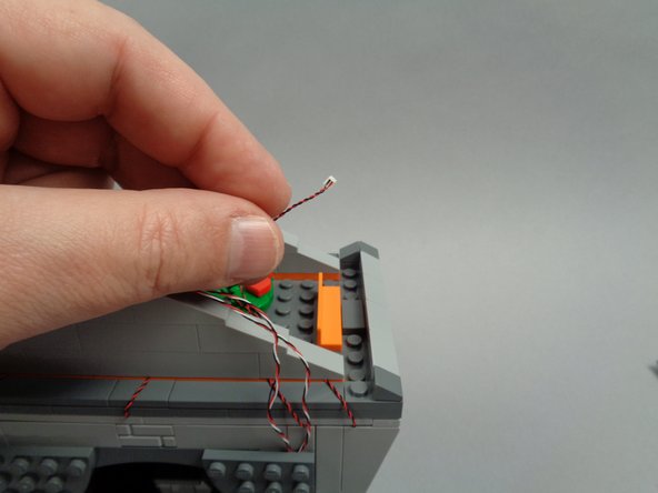 As shown in the first photo for this step, take the wire for the right torch light.