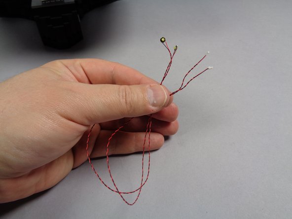 As shown in the first and second photos for this step, take the two cool white Pico LED lights from Bag 1, and place one Pico LED in the center of each engine.