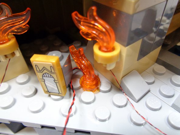 Make sure the light is positioned between the studs, and that its wire extends toward the rear of the Mirror of Erisred room as shown in the first photo.