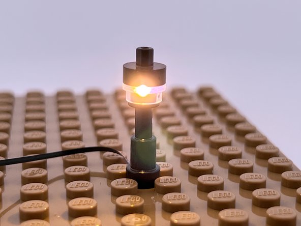 The yellow arrows in the first photo for this step show how you will pass the Microflex LED light through the bottom of each lamp post, then up through the hole in the center and out the top.