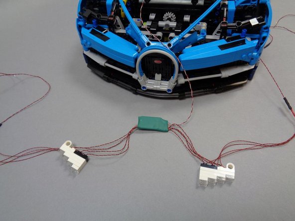 Open Bag 2 (labeled &quot;Headlight Assembly&quot;) and carefully remove the pre-assembled headlight pair from the bag.