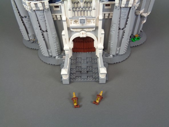 As shown in the first two photos, remove the two front torches from either side of the main castle door.