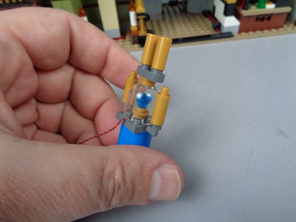 Re-attach the top of the jewel case.  The third photo shows the re-assembled case with the LED light wire passing out the back.