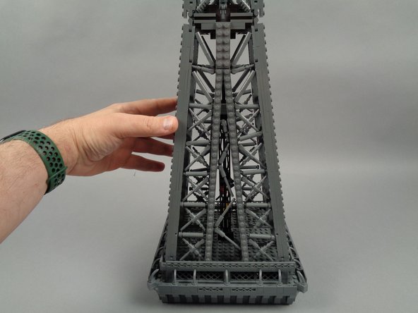 Position the top section of your Eiffel Tower as shown in the photos for this step, with the small elevator cars inside the structure facing away from you.