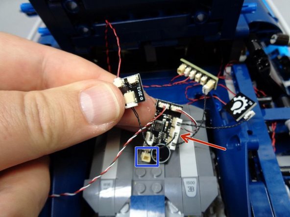 Now would be a good time to double-check that you have all lights connected to the correct plugs on the main controller board.  Only one plug should still be open: the single plug at the bottom of the board (blue square, third photo).  This is where you will connect the power supply in a later step.